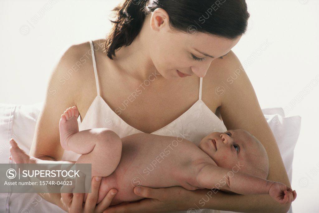 Stock Photo: 1574R-04023 Close-up of a mother carrying her baby boy