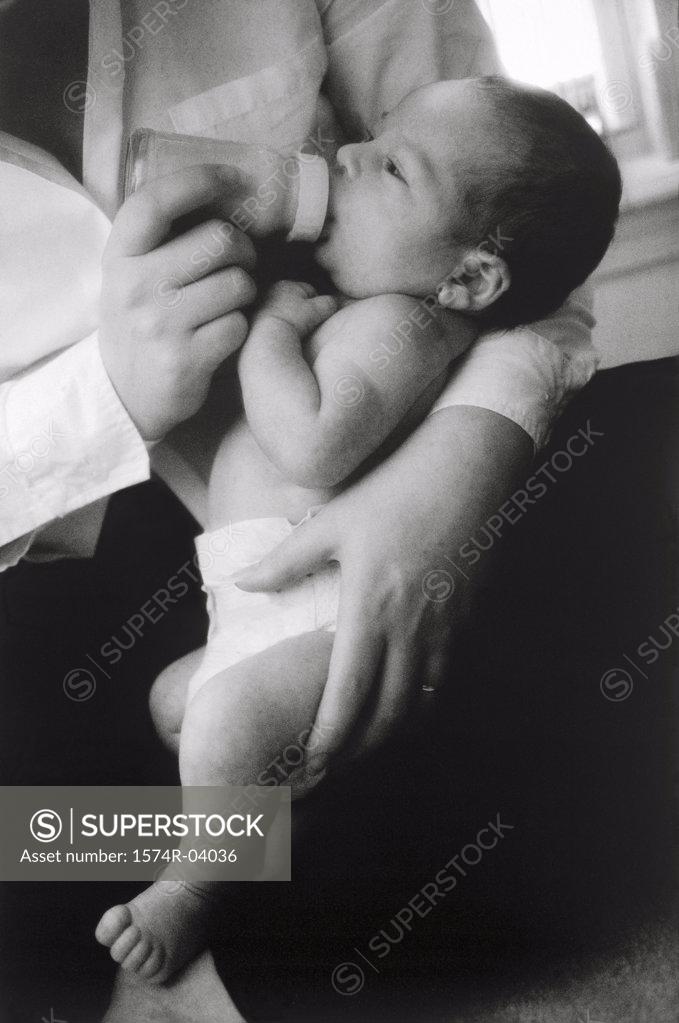Stock Photo: 1574R-04036 Close-up of a baby boy drinking milk from a feeding bottle