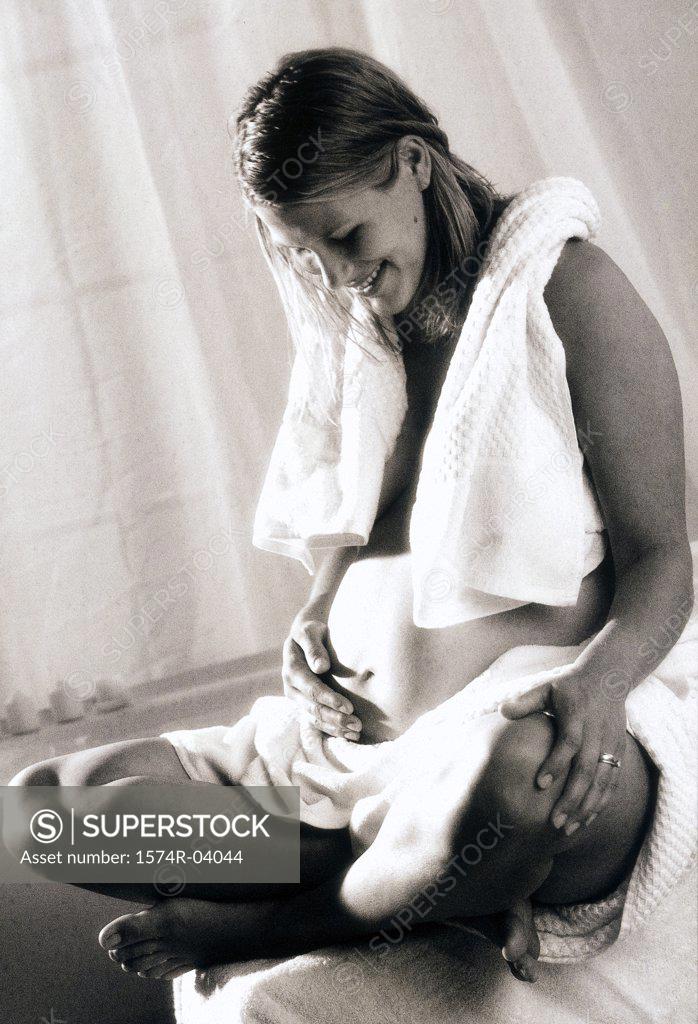 Stock Photo: 1574R-04044 Pregnant woman touching her abdomen