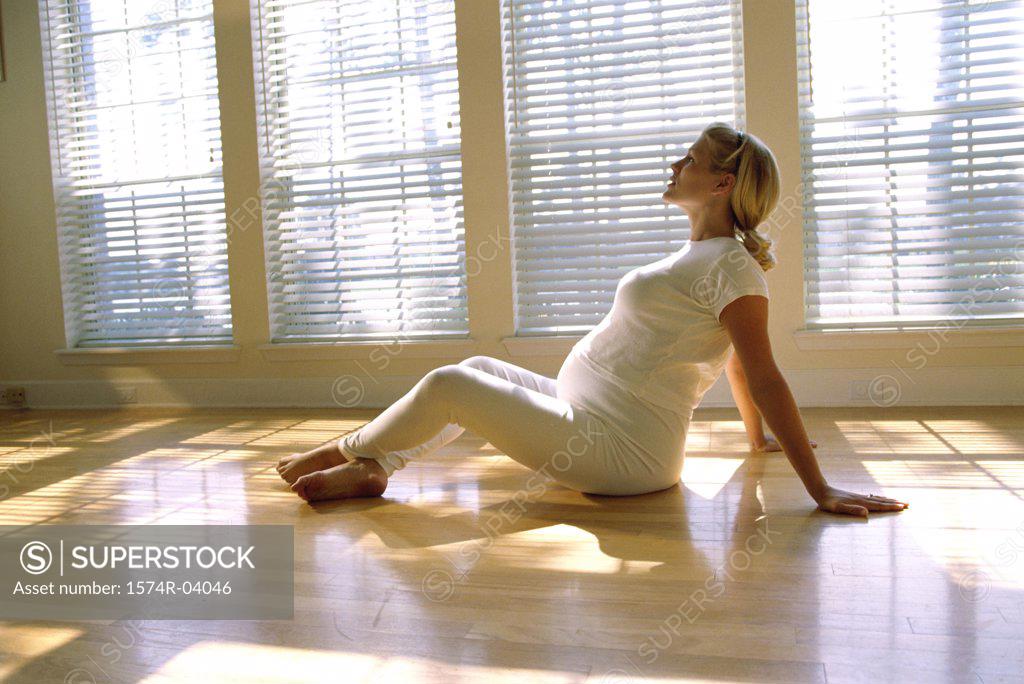 Stock Photo: 1574R-04046 Pregnant woman sitting on the floor