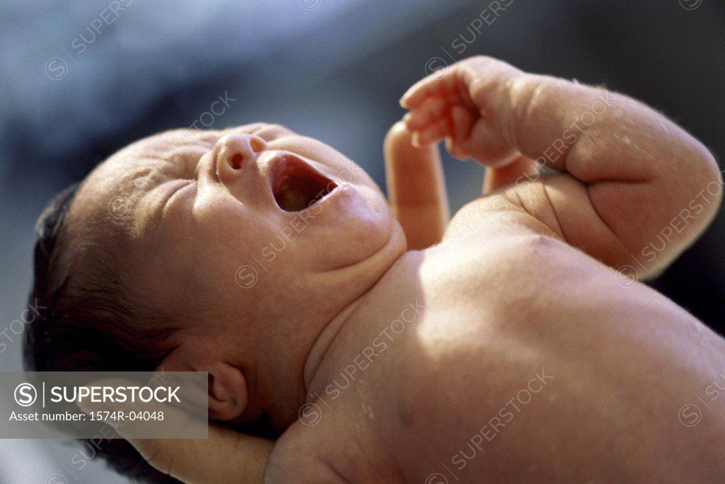 Stock Photo: 1574R-04048 Person carrying a newborn baby boy