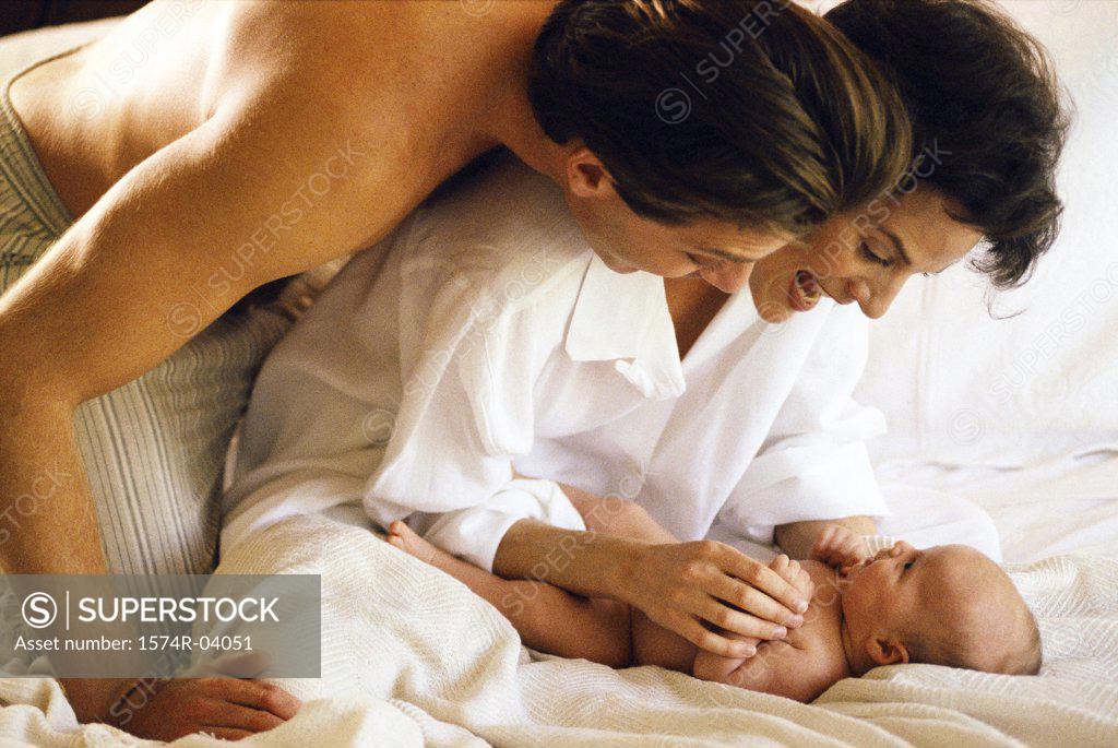 Stock Photo: 1574R-04051 Parents playing with their baby boy