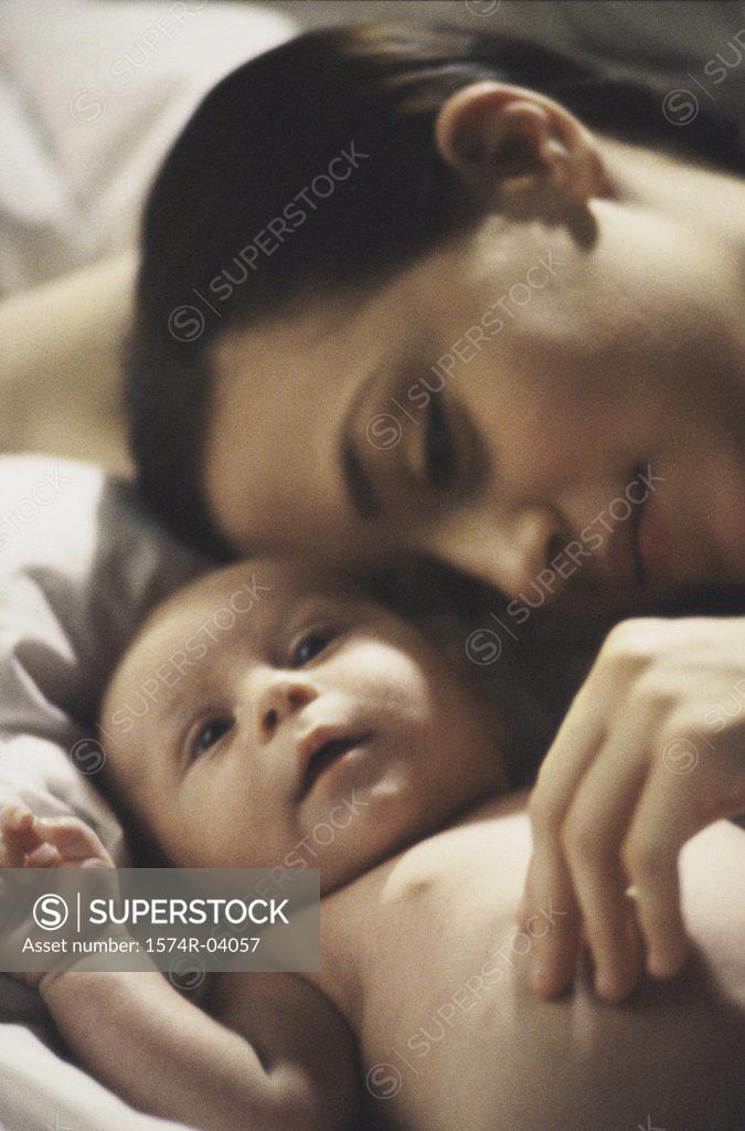 Stock Photo: 1574R-04057 Close-up of a mother lying down with her baby boy