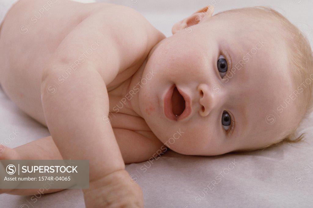 Stock Photo: 1574R-04065 Close-up of a baby boy lying on his side