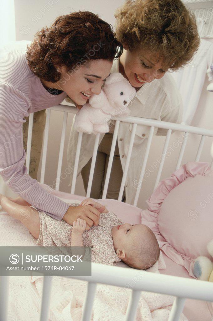 Stock Photo: 1574R-04067 Mother and grandmother playing with a baby girl