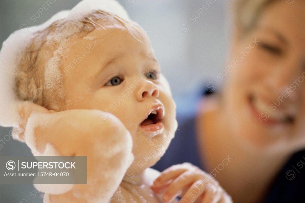 Stock Photo: 1574R-04070 Close-up of a baby boy getting a bath from his mother