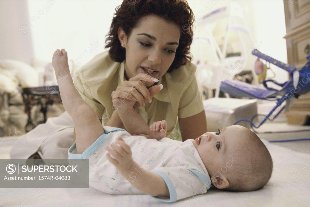 Stock Photo: 1574R-04083 Mother playing with her baby girl