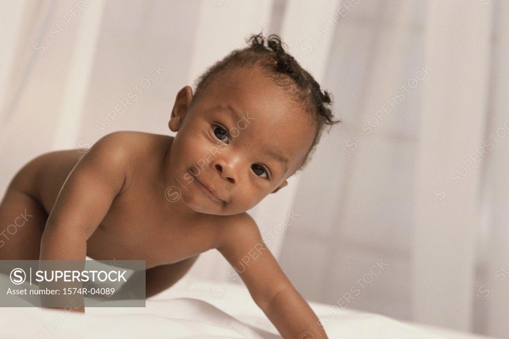 Stock Photo: 1574R-04089 Portrait of a baby boy crawling
