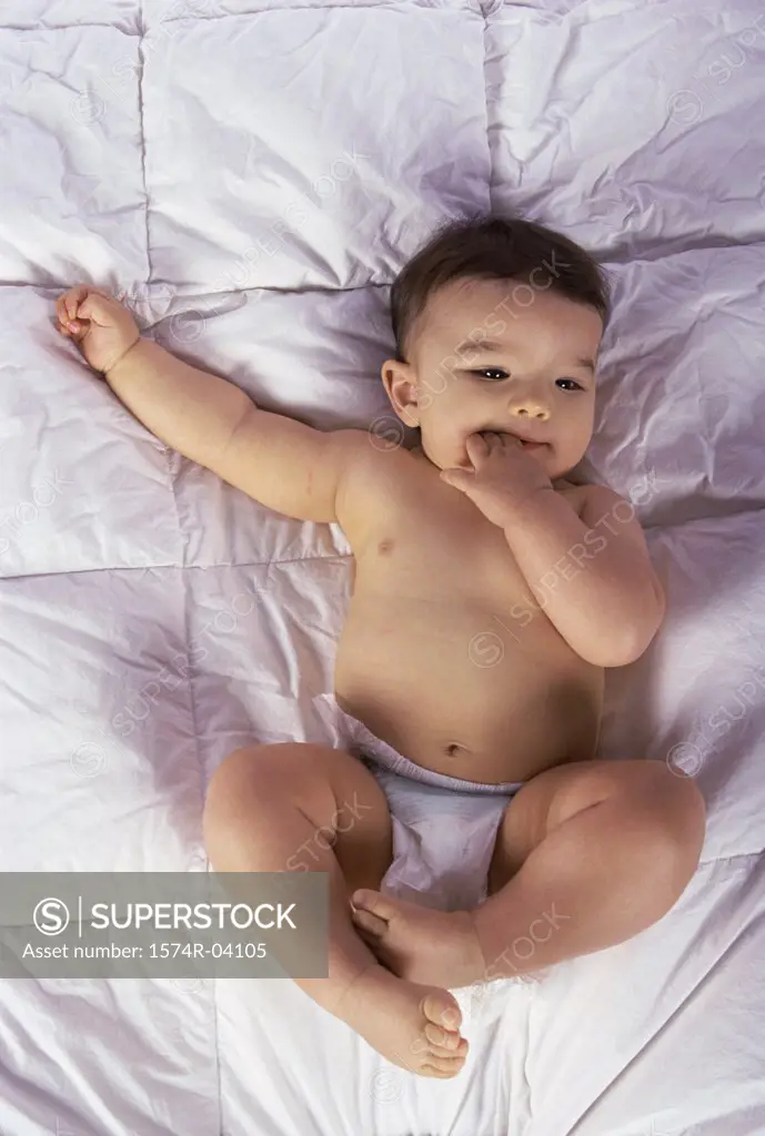 High angle view of a baby boy lying on a bed