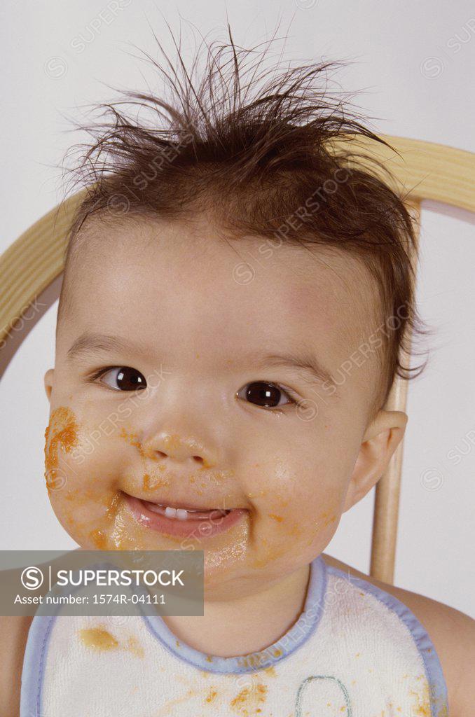 Stock Photo: 1574R-04111 Portrait of a baby boy smiling with food on his face