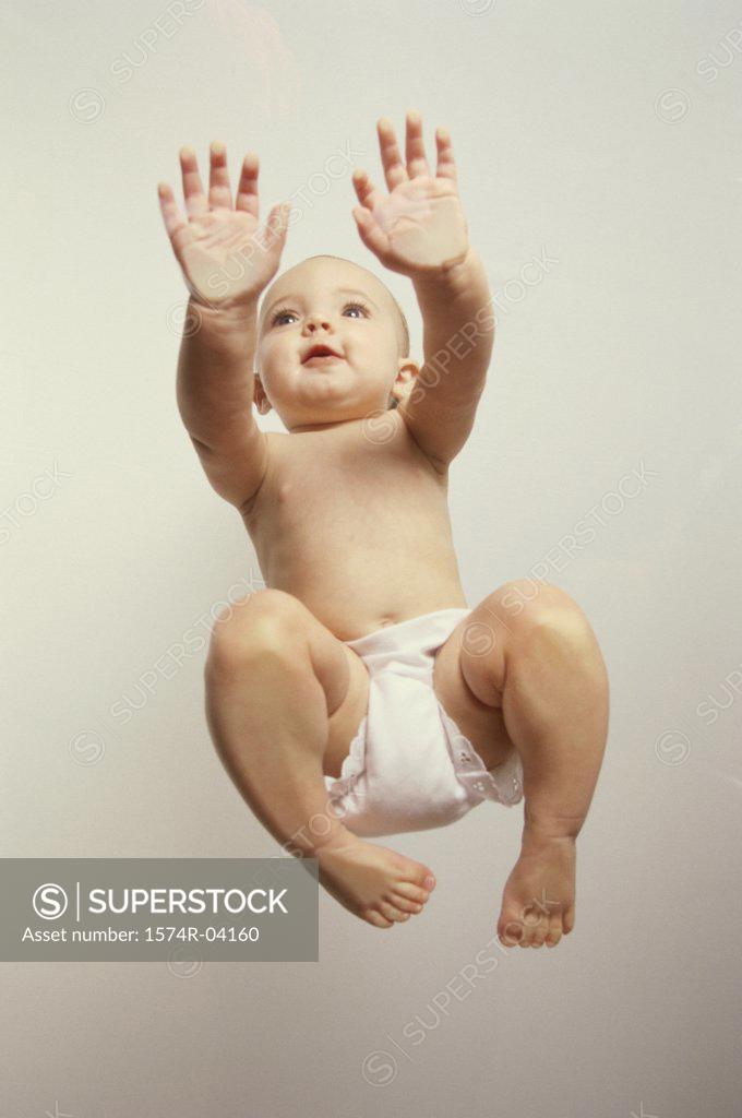 Stock Photo: 1574R-04160 Low angle view of a baby girl crawling