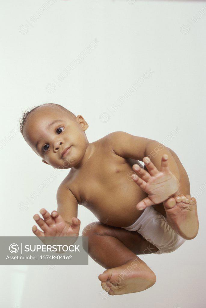 Stock Photo: 1574R-04162 Low angle view of a baby boy sitting on all fours