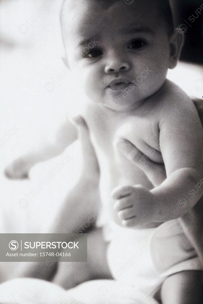 Stock Photo: 1574R-04166 Close-up of a baby boy in a person's hands