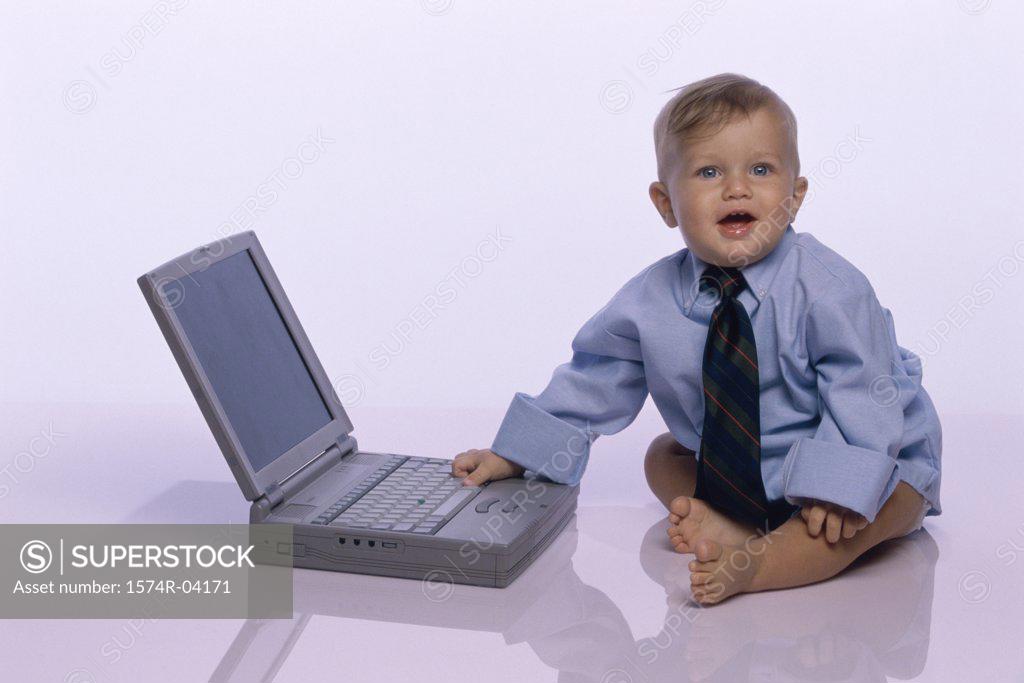 Stock Photo: 1574R-04171 Baby boy touching a laptop