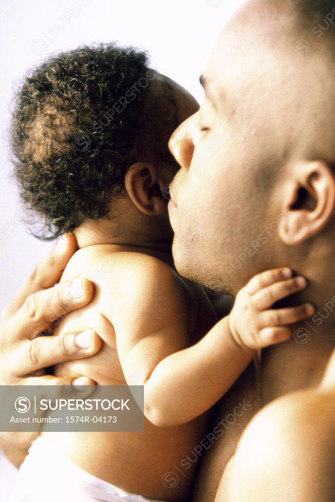 Stock Photo: 1574R-04173 Close-up of a father hugging his baby boy