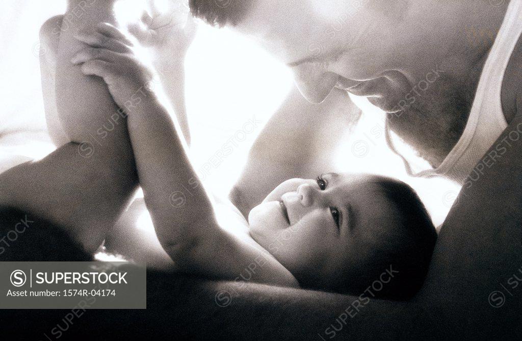 Stock Photo: 1574R-04174 Close-up of a father playing with his baby boy