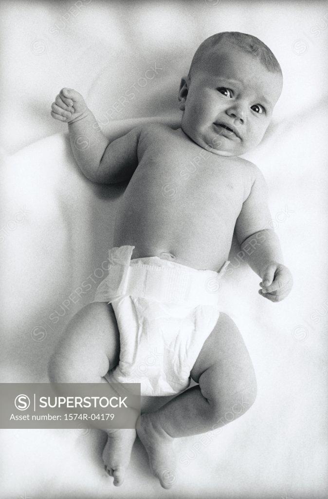 Stock Photo: 1574R-04179 Portrait of a baby boy lying on a bed