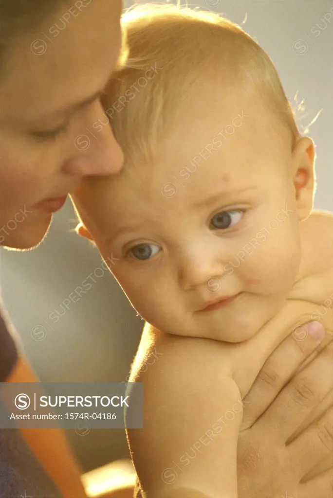 Close-up of mother holding her baby boy