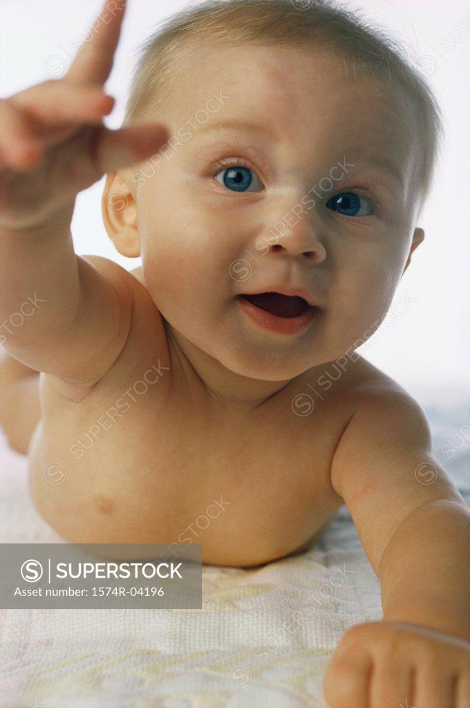 Stock Photo: 1574R-04196 Portrait of a baby boy raising his hand