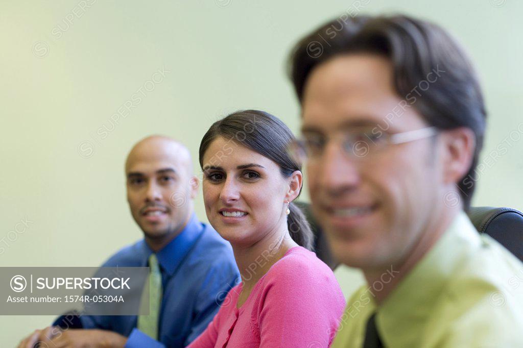 Stock Photo: 1574R-05304A Two businessmen and a businesswoman sitting in a conference room