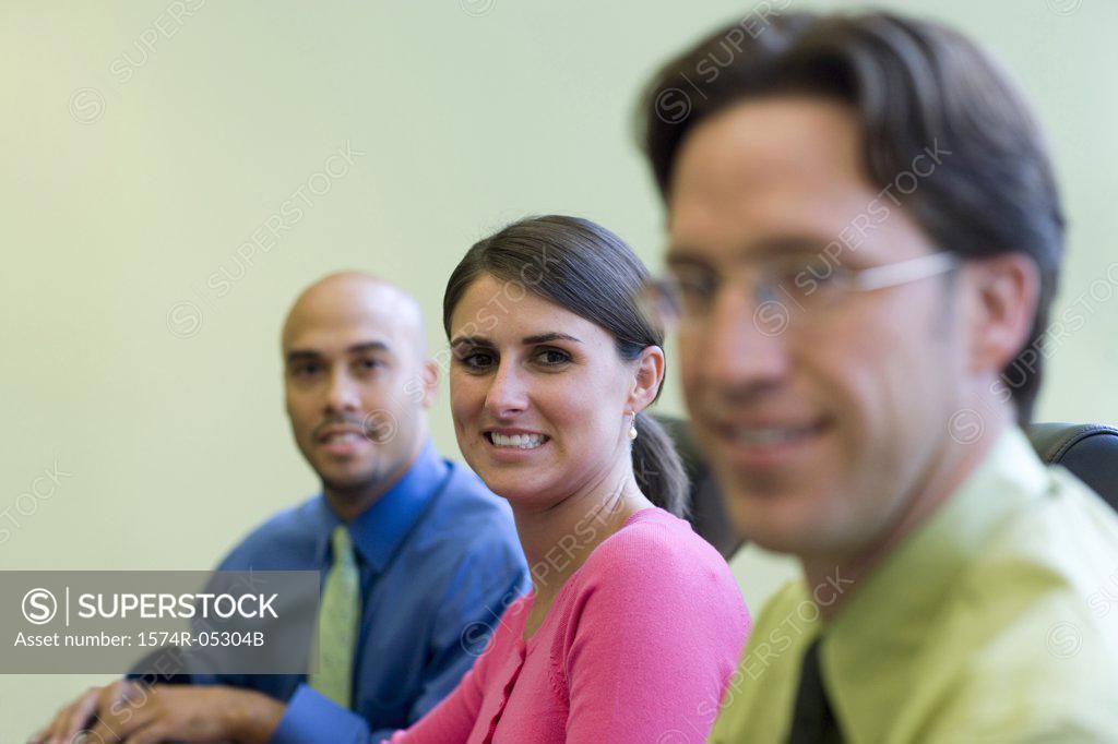 Stock Photo: 1574R-05304B Portrait of two businessmen and a businesswoman sitting in an office