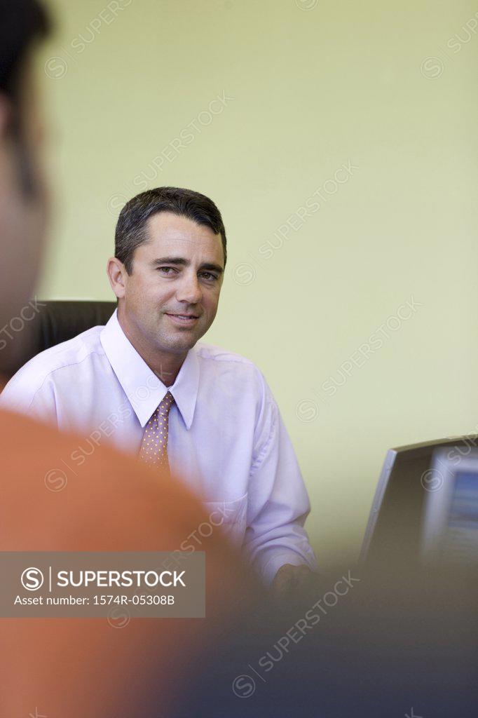 Stock Photo: 1574R-05308B Portrait of a businessman sitting in an office
