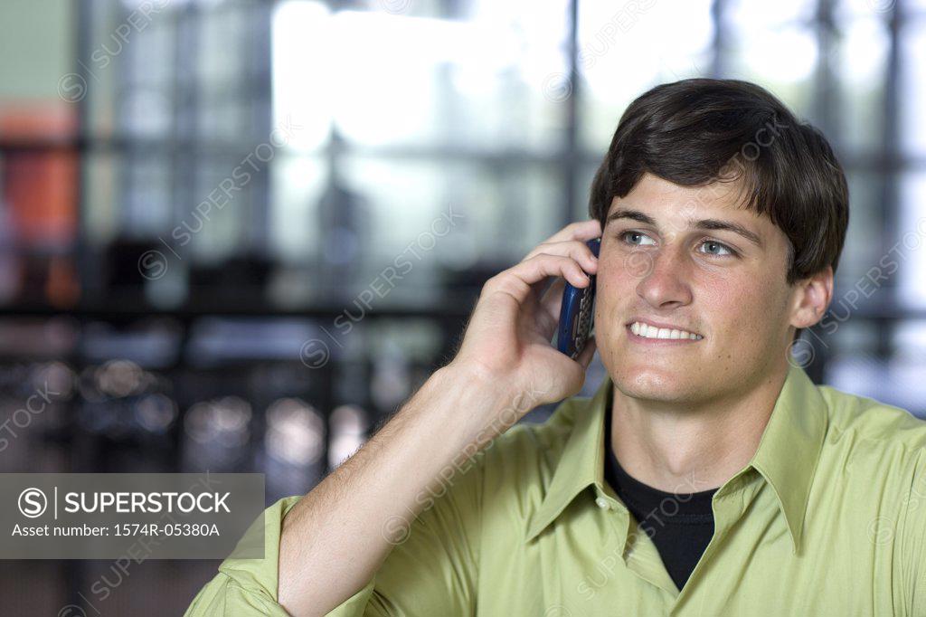 Stock Photo: 1574R-05380A Businessman using a mobile phone in an office