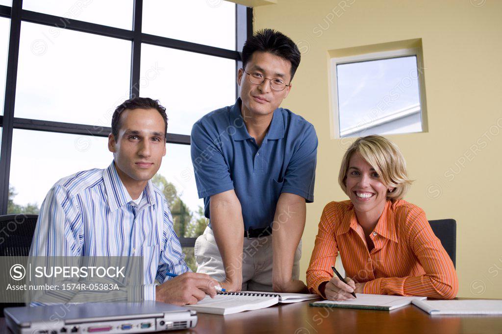 Stock Photo: 1574R-05383A Portrait of two businessmen and a businesswoman in a conference room