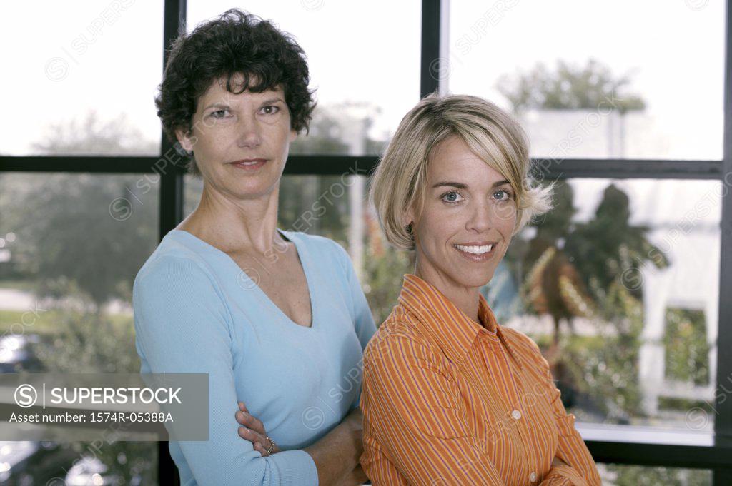 Stock Photo: 1574R-05388A Portrait of two businesswomen smiling in an office