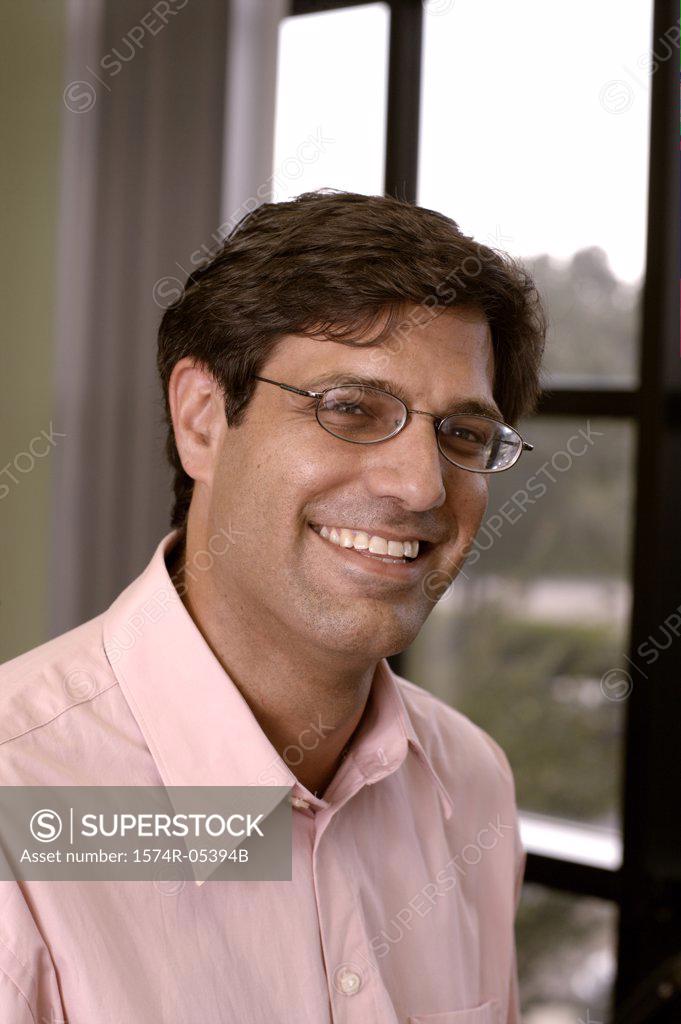 Stock Photo: 1574R-05394B Portrait of a businessman smiling in an office