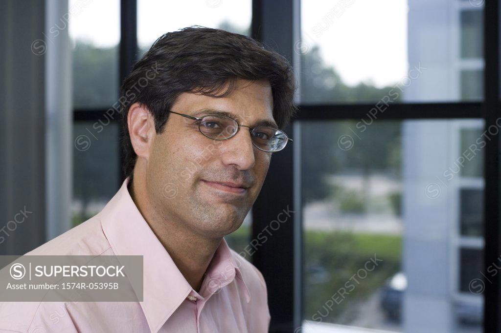 Stock Photo: 1574R-05395B Portrait of a businessman smiling in an office