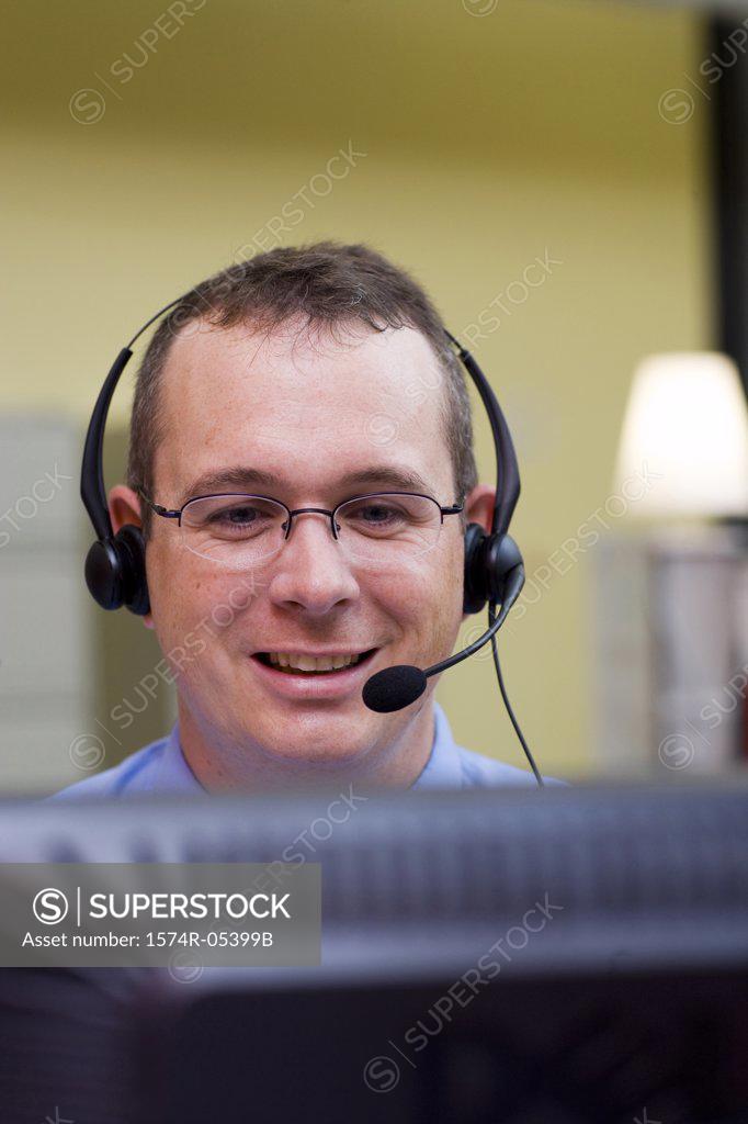 Stock Photo: 1574R-05399B Businessman wearing a headset in an office