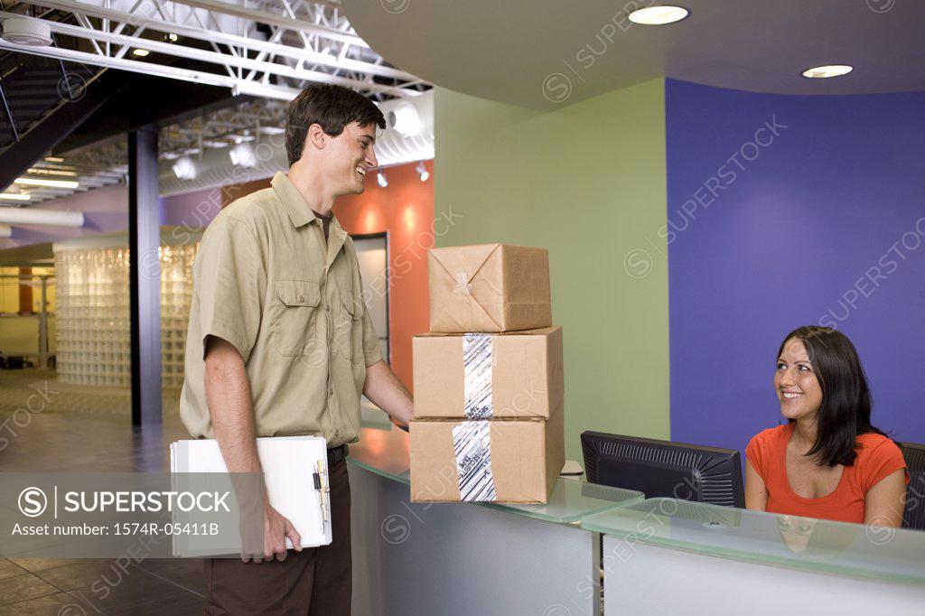 Stock Photo: 1574R-05411B Receptionist receiving a package from a delivery man
