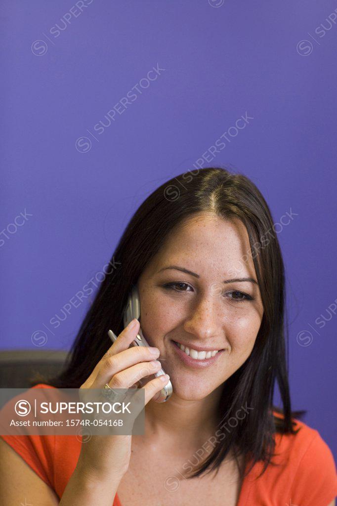 Stock Photo: 1574R-05416B Close-up of a businesswoman talking on a mobile phone in an office