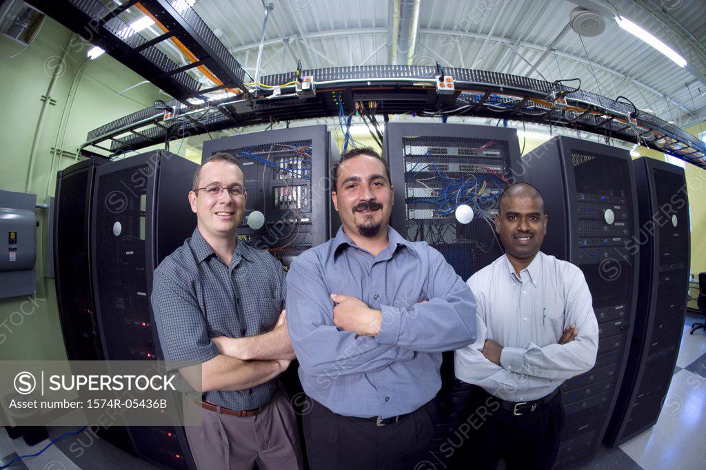 Stock Photo: 1574R-05436B Portrait of three technicians standing in a server room