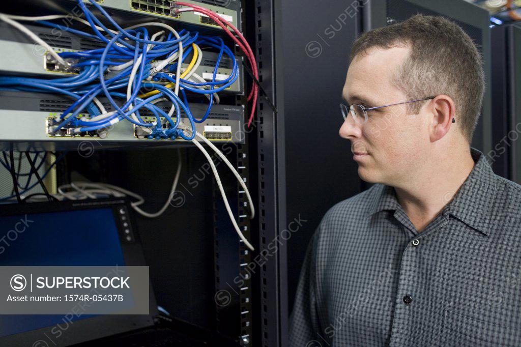 Stock Photo: 1574R-05437B Close-up of a technician looking at a network server