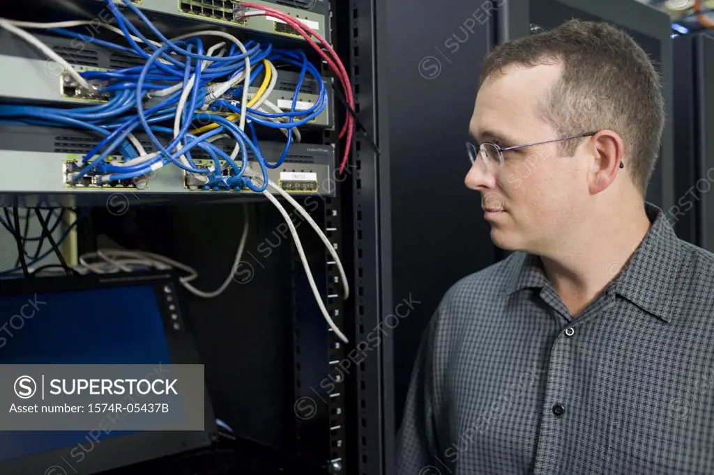 Close-up of a technician looking at a network server