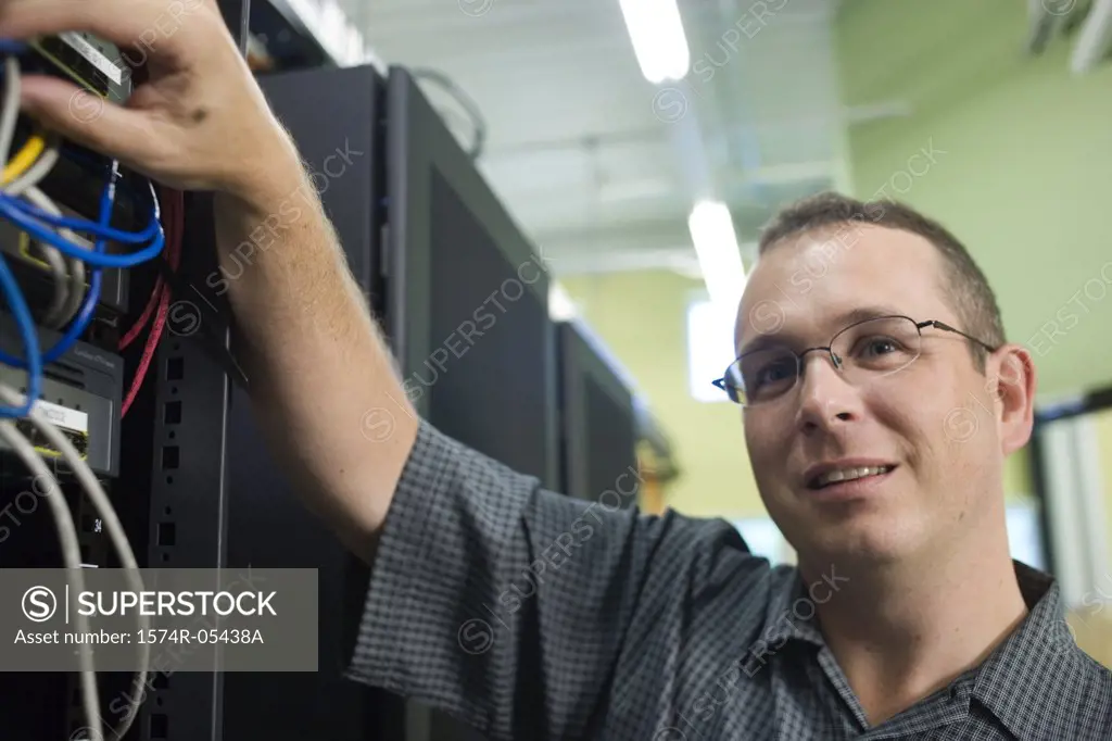 Close-up of a technician checking cables of a computer network
