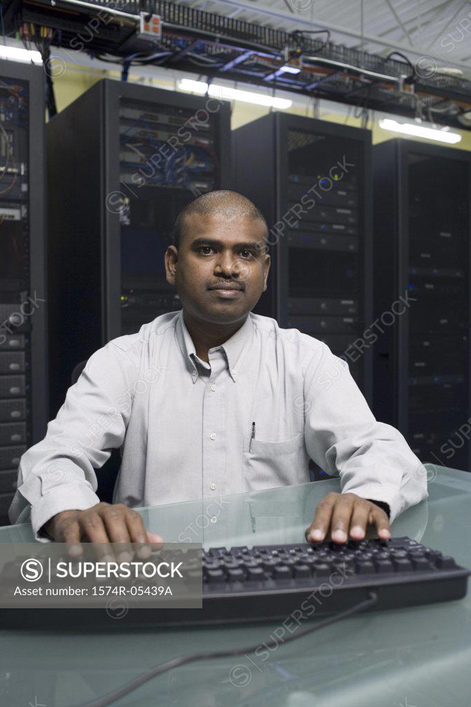 Stock Photo: 1574R-05439A Portrait of a technician working on a network server