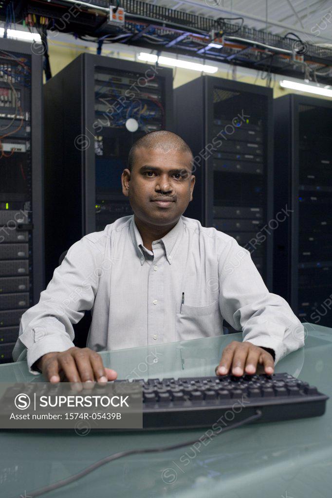 Stock Photo: 1574R-05439B Portrait of a technician using a computer in a server room