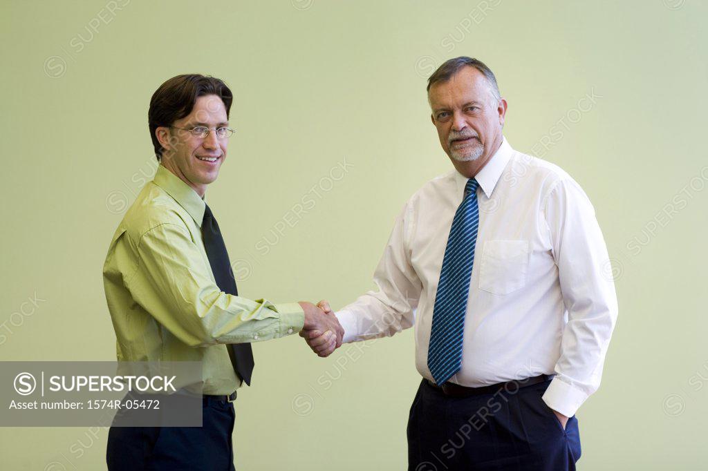 Stock Photo: 1574R-05472 Portrait of two businessmen shaking hands