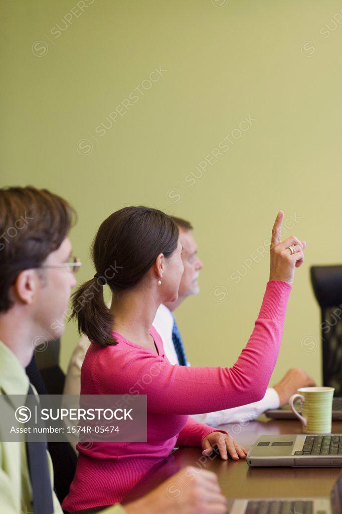 Stock Photo: 1574R-05474 Businesswoman raising her hand in a conference