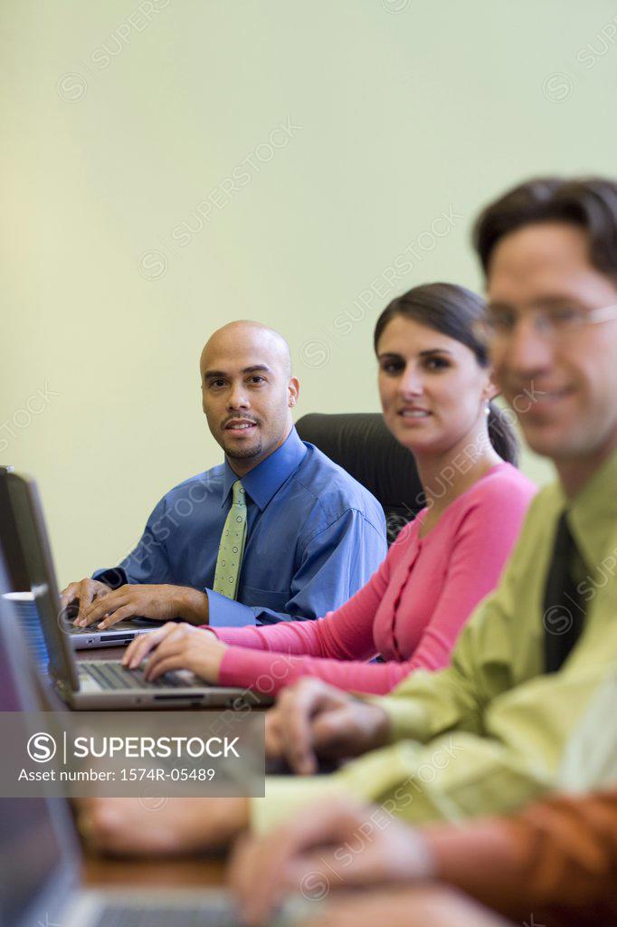 Stock Photo: 1574R-05489 Portrait of a group of business executives sitting around a conference table