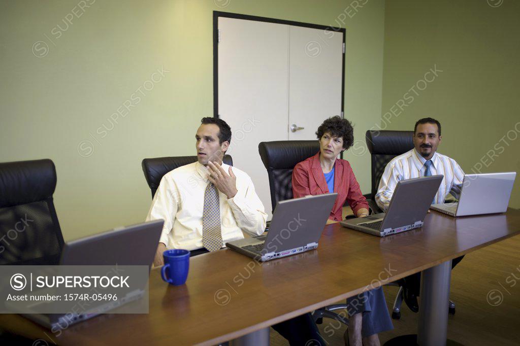 Stock Photo: 1574R-05496 Two businessmen and a businesswoman in a conference