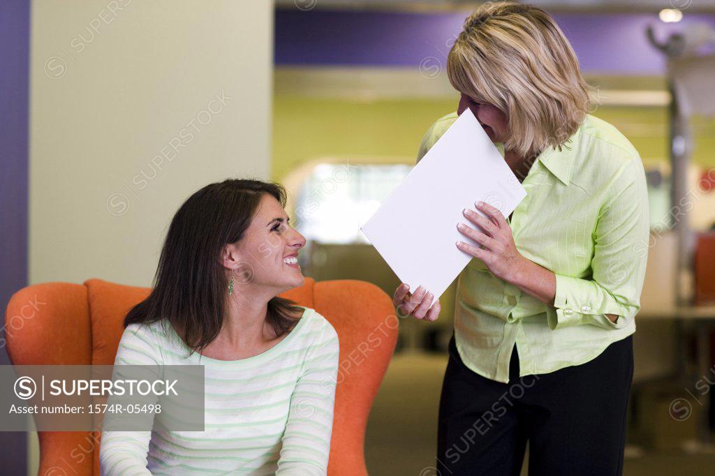Stock Photo: 1574R-05498 Two businesswomen talking in an office