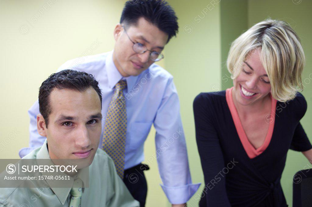 Stock Photo: 1574R-05611 Two businessmen and a businesswoman in a meeting