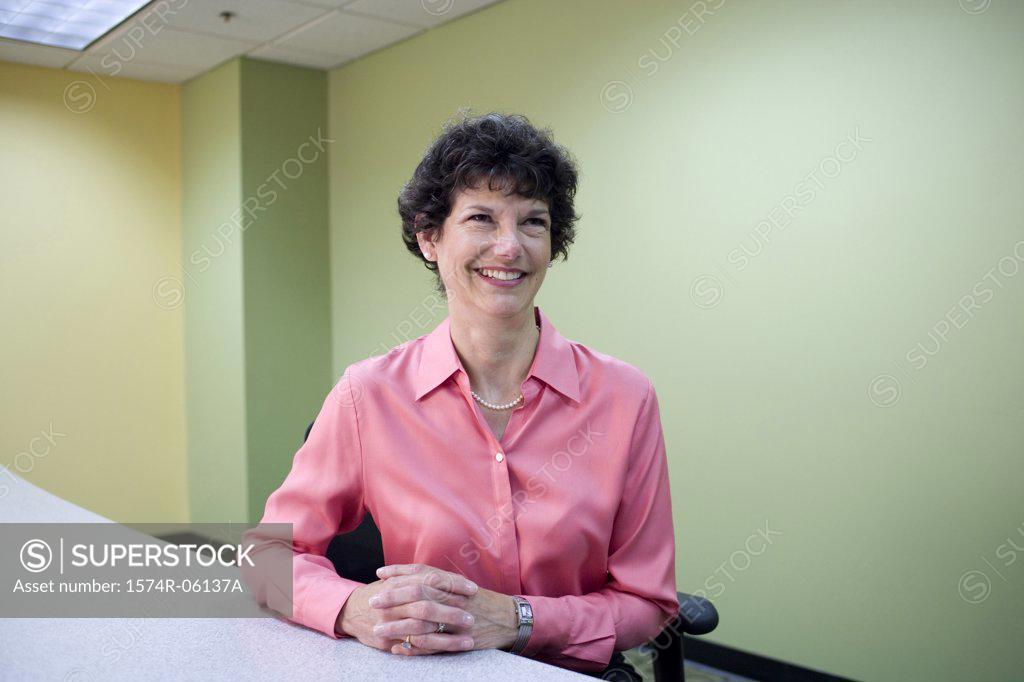 Stock Photo: 1574R-06137A Businesswoman sitting in an office