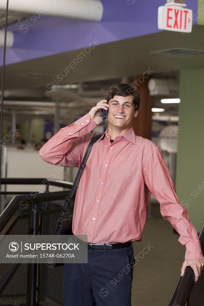 Stock Photo: 1574R-06270A Portrait of a businessman talking on a mobile phone in an office