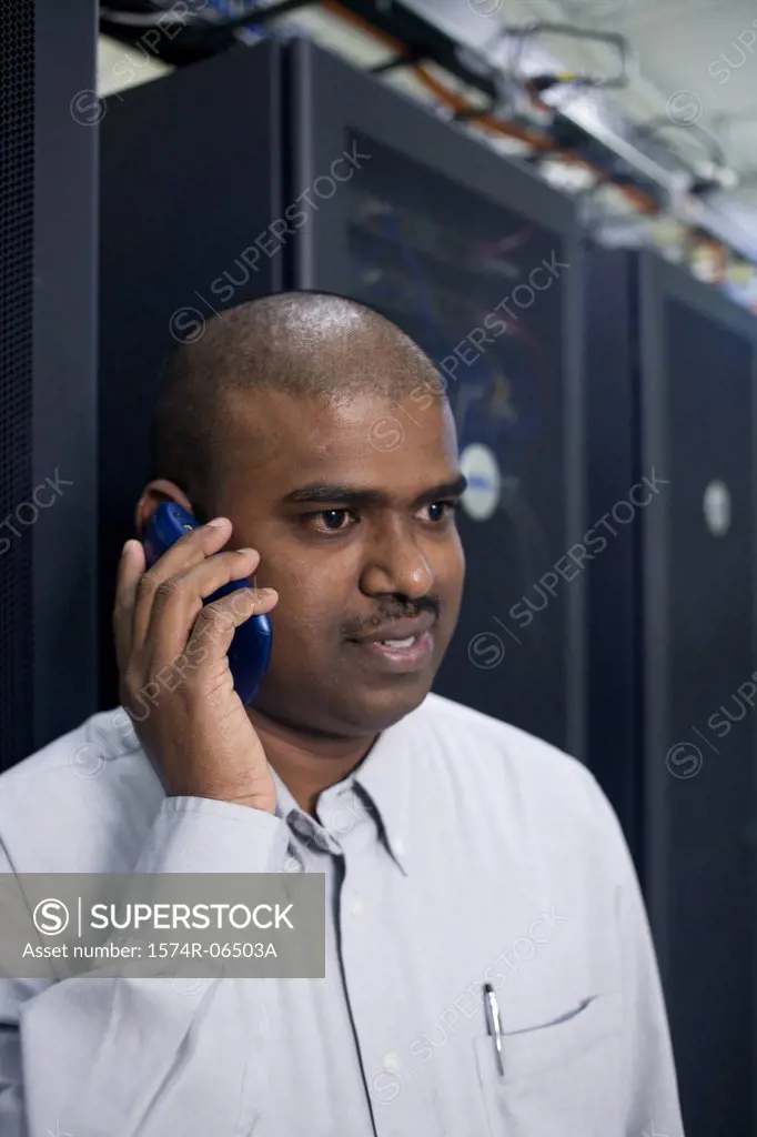 Close-up of a technician talking on a mobile phone