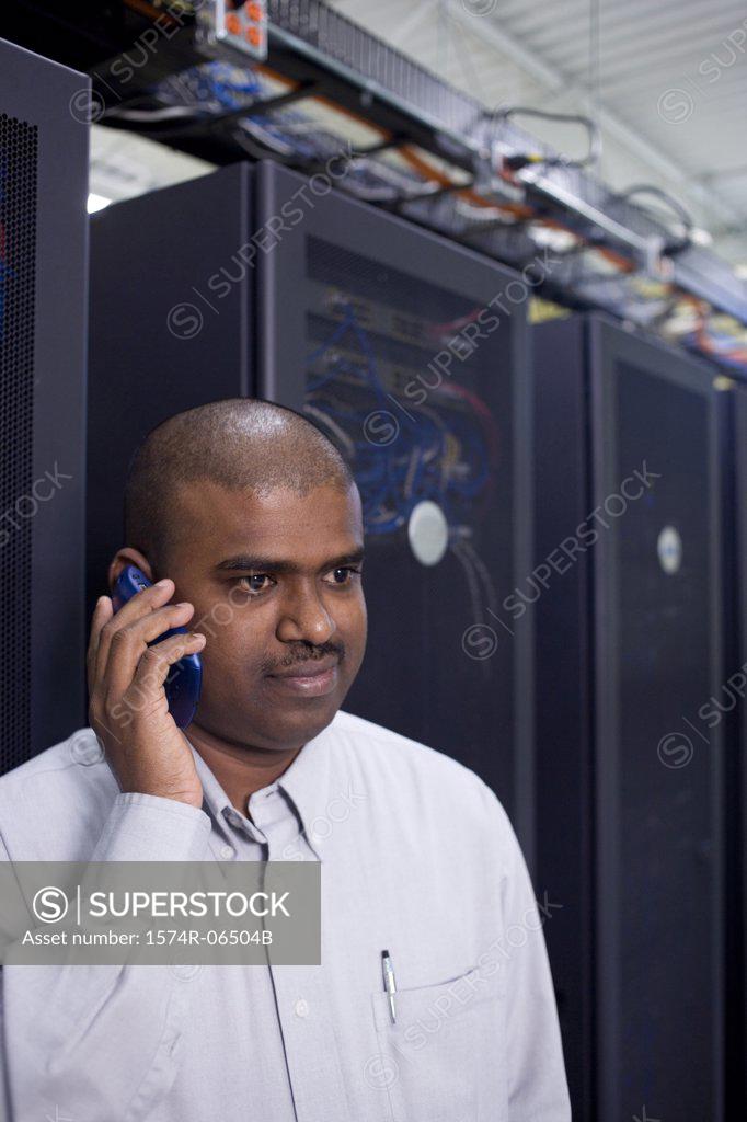 Stock Photo: 1574R-06504B Close-up of a technician talking on a mobile phone